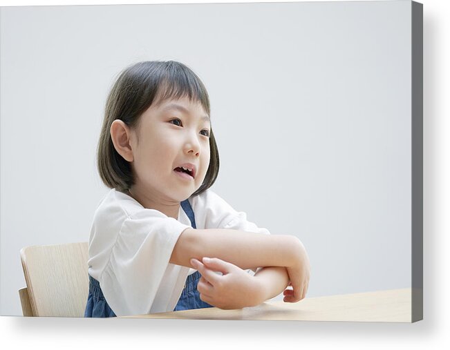 Toddler Acrylic Print featuring the photograph Asian girl feeling itchy on the chair by Kokoroyuki