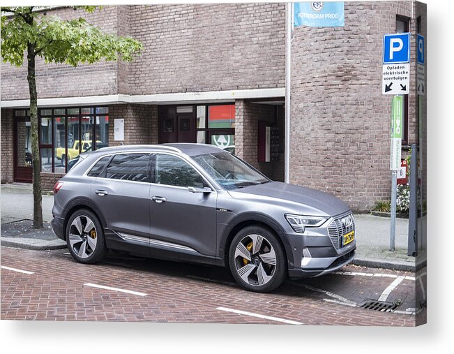 Environmental Conservation Acrylic Print featuring the photograph Audi e-tron 55 quattro electric SUV at an electric vehicle charging station in the city by Sjo
