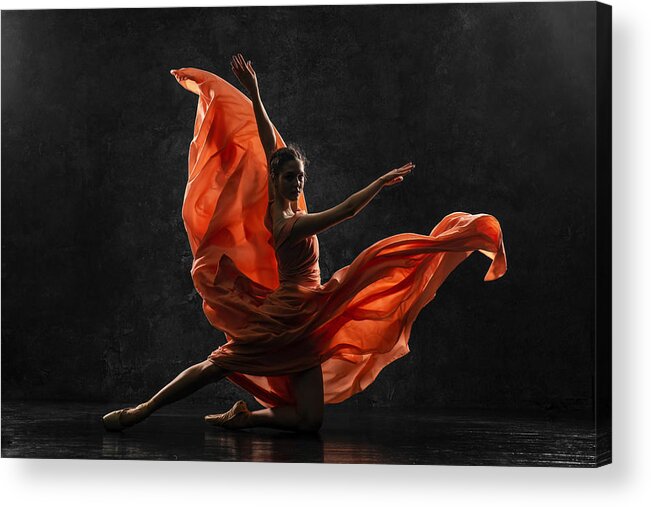 Ballet Dancer Acrylic Print featuring the photograph Ballerina. Silhouette photo of a young ballet dancer dressed in a long peach dress, pointe shoes with ribbons. The girl performs an graceful dance movement. Beautiful classic ballet. Ballet studios. by Anna Fedoseeva