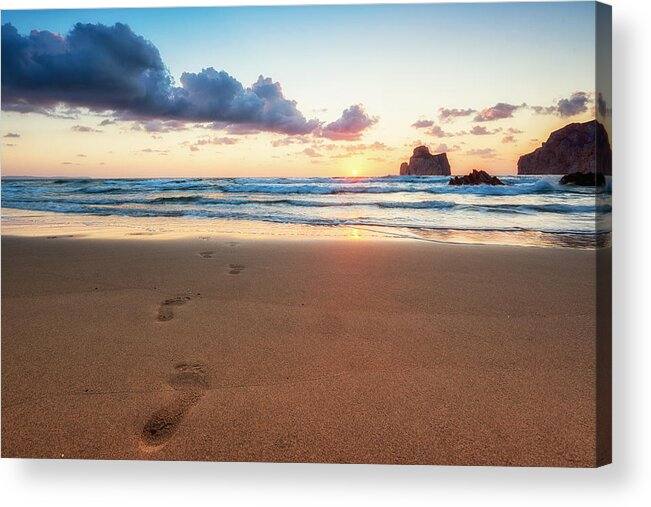 Southern Italy Acrylic Print featuring the photograph Beautiful and warm sunset with little clouds. Footprints in the sand in the foreground, Pan di Zucchero in the background. Masua beach, Sardinia, Italy, Europe by Andrea Comi