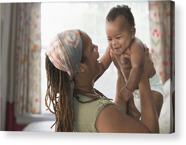 Three Quarter Length Acrylic Print featuring the photograph Black mother lifting baby son by Jose Luis Pelaez Inc