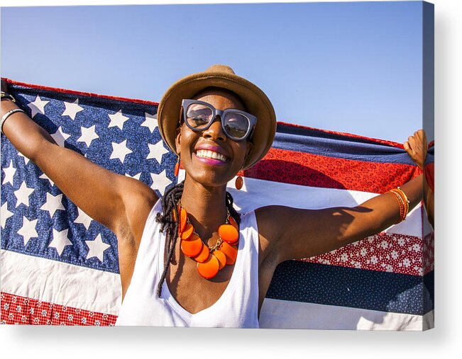 Cool Attitude Acrylic Print featuring the photograph Black woman holding American flag under blue sky by Adam Hester
