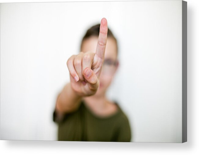 Hand Raised Acrylic Print featuring the photograph boy hand with index finger.Selective focus by Carol Yepes