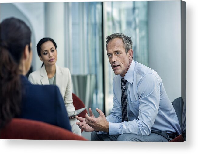 Jacket Acrylic Print featuring the photograph Businessman discussing strategy with colleagues by Morsa Images