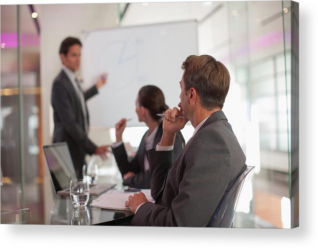 Explaining Acrylic Print featuring the photograph Businessman talking to co-workers in conference room by Paul Bradbury