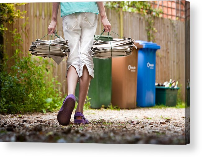 Newspaper Acrylic Print featuring the photograph Child recycling newspapers. by Tim Platt