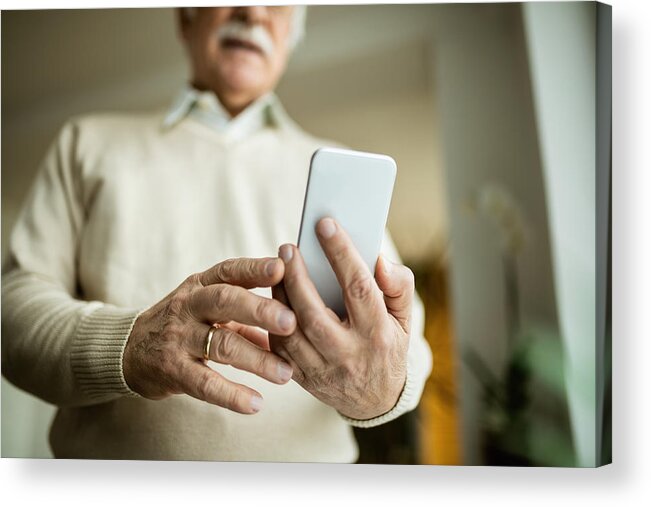 Internet Acrylic Print featuring the photograph Close-up of mature man using smart phone. by Drazen Zigic