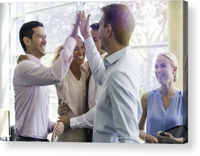 Holding Acrylic Print featuring the photograph Colleagues giving each other high-five by PhotoAlto/Eric Audras