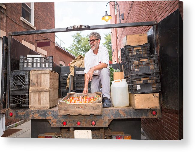 Working Acrylic Print featuring the photograph Farmer unloading crates of organic tomatoes outside grocery store by Heshphoto