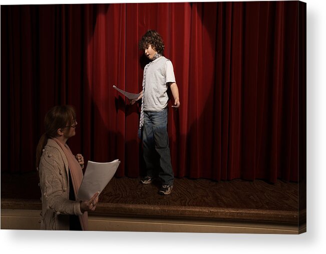 Mature Women Acrylic Print featuring the photograph Female teacher and boy (10-12) standing on stage rehearsing by Adam Taylor