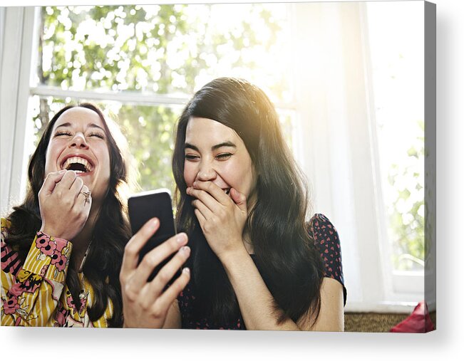People Acrylic Print featuring the photograph Friends laughing at a mobile phone by Ezra Bailey