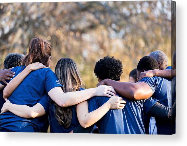 Young Men Acrylic Print featuring the photograph Friends linking arms in unity by SDI Productions
