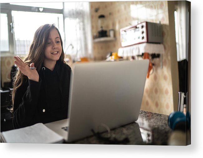 Voip Acrylic Print featuring the photograph Girl studying and making a video call via laptop at home by FG Trade