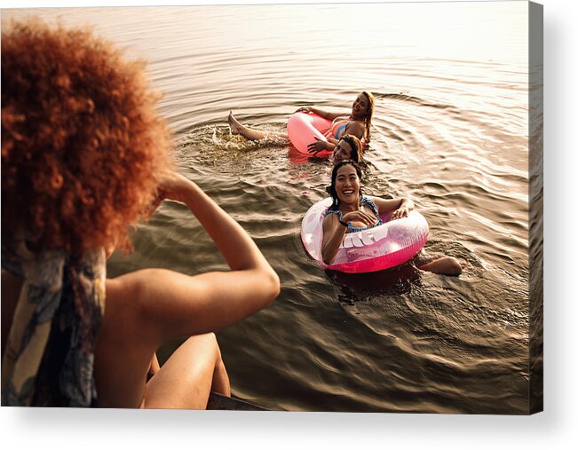 People Acrylic Print featuring the photograph Group of female friends enjoying a summer day swimming at the lake. by Zoran Zeremski