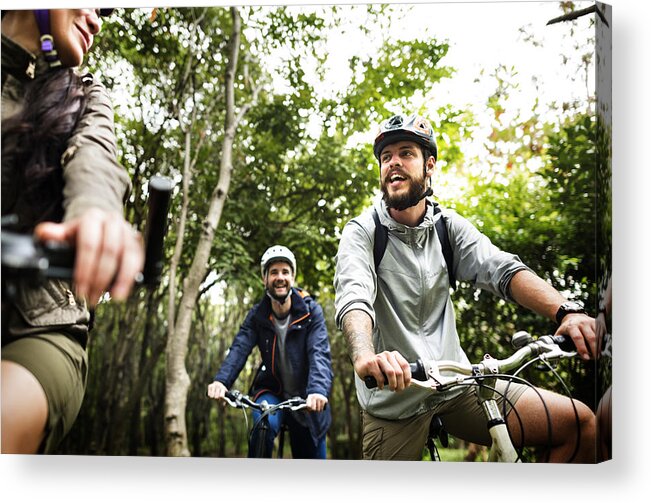International Match Acrylic Print featuring the photograph Group of friends ride mountain bike in the forest together by Rawpixel