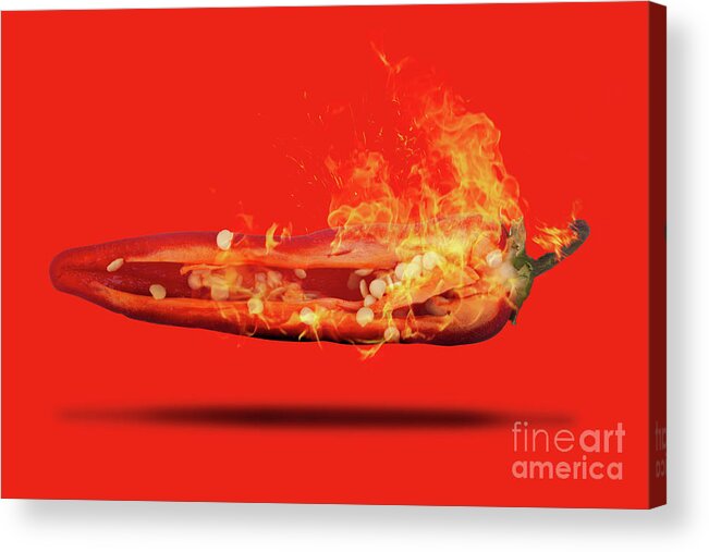 Red Acrylic Print featuring the photograph Half a red chili pepper on fire with seeds by Simon Bratt