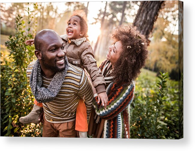 Child Acrylic Print featuring the photograph Happy black parents having fun with their daughter at the park. by Skynesher