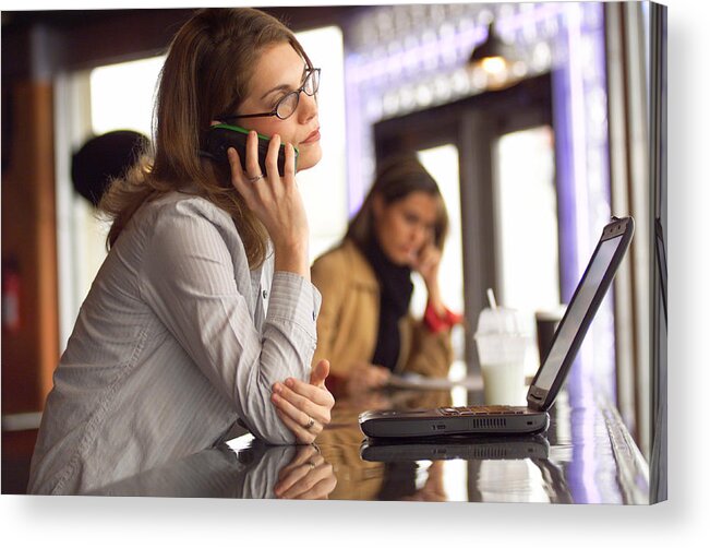Caucasian Ethnicity Acrylic Print featuring the photograph Lifestyle Photograph Of An Attractive Caucasian Female As She Talks On A Cell Phone In A Cafe by Photodisc