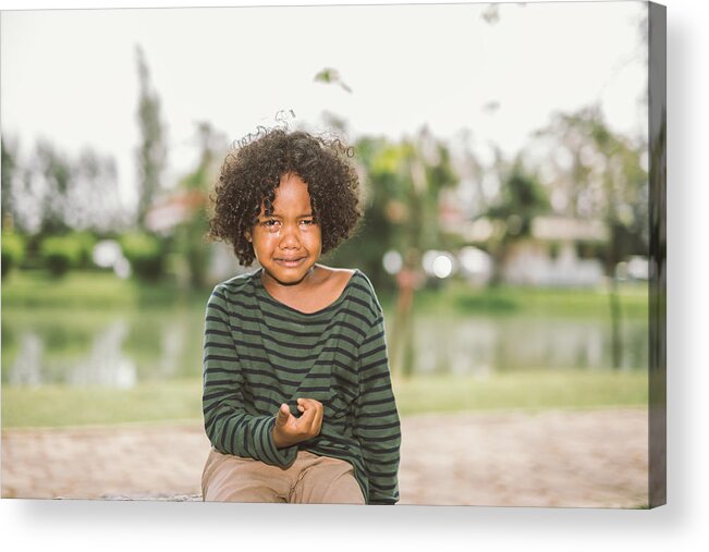 Toddler Acrylic Print featuring the photograph little African american boy crying by Pondsaksit