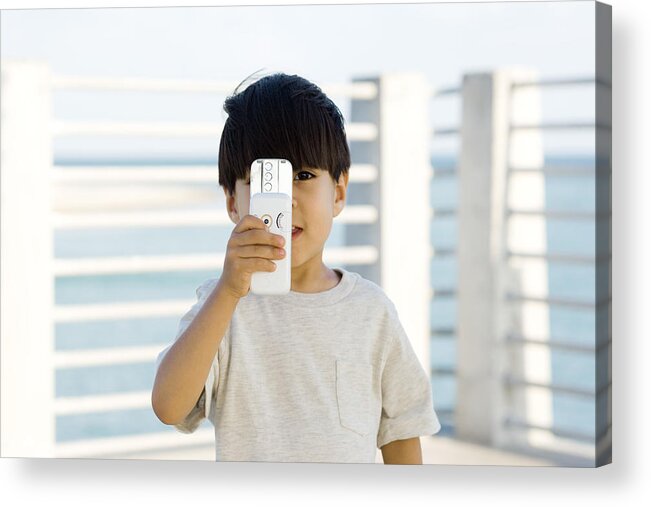 4-5 Years Acrylic Print featuring the photograph Little boy holding slide camera phone in front of face, looking at camera by PhotoAlto/Frederic Cirou