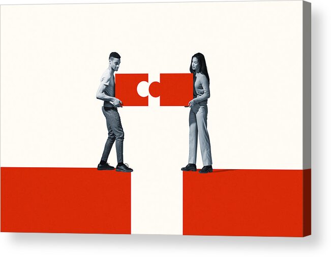 Young Men Acrylic Print featuring the photograph Man and woman positioning orange puzzle pieces by Klaus Vedfelt
