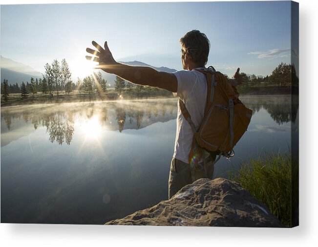 Three Quarter Length Acrylic Print featuring the photograph Man spreads arms wide across mountain lake by Ascent Xmedia