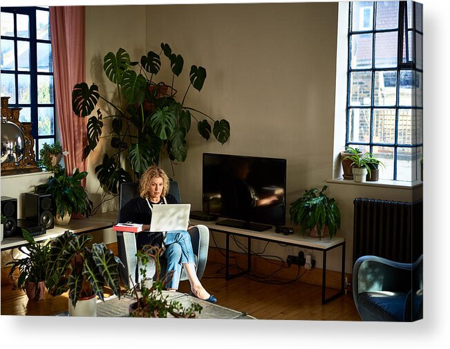 Internet Acrylic Print featuring the photograph Mature woman using laptop in living room by 10'000 Hours