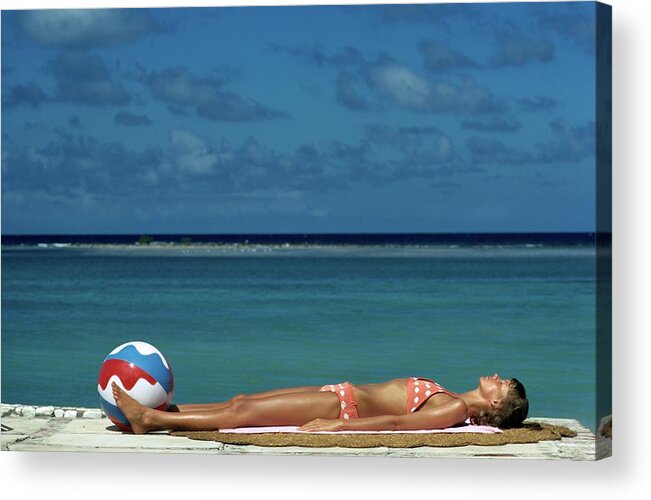 Fashion Acrylic Print featuring the photograph Model Lying on the Beach in a Polka Dot Bikini by Mike Reinhardt