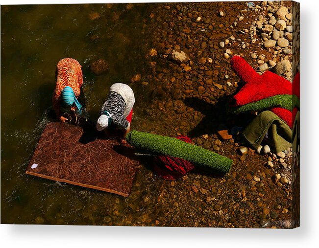 Grass Acrylic Print featuring the photograph People wash the carpets alongside the river in rural area by Redtea