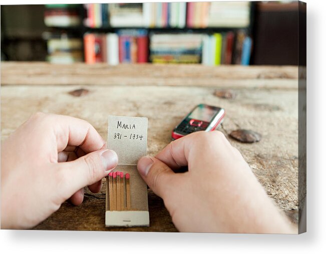 People Acrylic Print featuring the photograph Person holding matchbook with phone number written on it by Image Source
