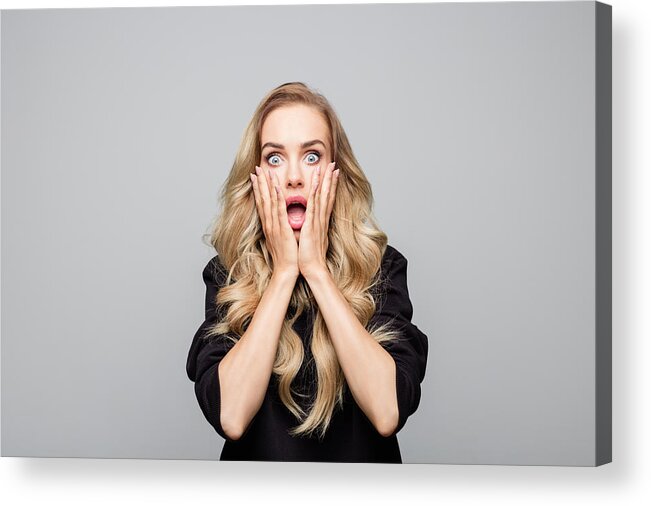 Disbelief Acrylic Print featuring the photograph Portrait of shocked young woman with hands on face by Izusek