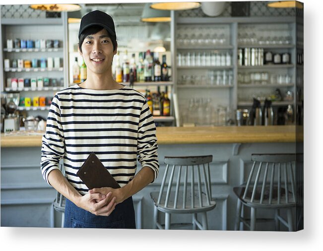 Young Men Acrylic Print featuring the photograph Portrait of young waiter in restaurant by Indeed