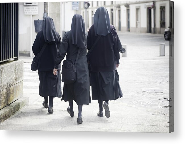 Pedestrian Acrylic Print featuring the photograph Rear view of three nuns walking in the street. by Percds