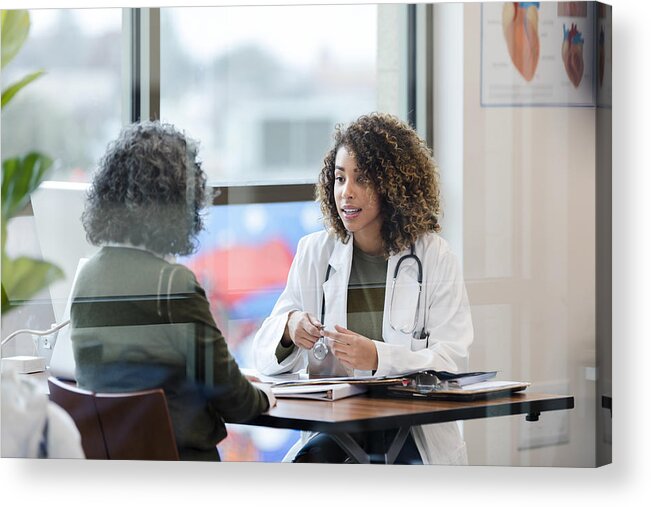 Internet Acrylic Print featuring the photograph Sitting in office, doctor has serious conversation with patient by SDI Productions