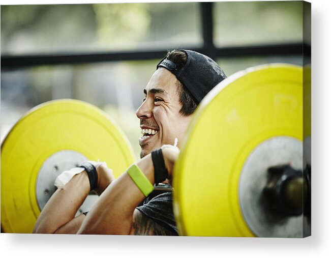 Toughness Acrylic Print featuring the photograph Smiling man preparing to press barbell over head by Thomas Barwick