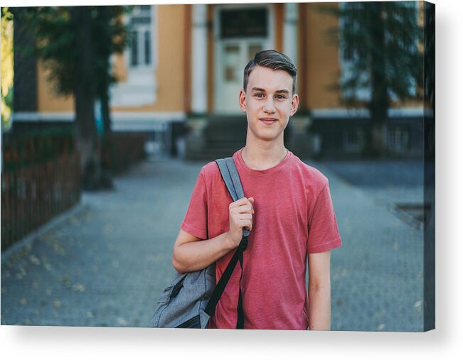 Bulgaria Acrylic Print featuring the photograph Smiling schoolboy in the schoolyard by Martin-dm