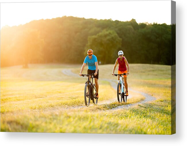 Electric Bicycle Acrylic Print featuring the photograph Smiling Sporty Couple On Mountain Bikes In Rural Landscape by Amriphoto