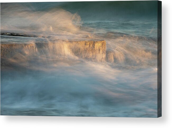 Stormy Sea Acrylic Print featuring the photograph Stormy windy sea waves splashing on a rocky seashore at sunset by Michalakis Ppalis