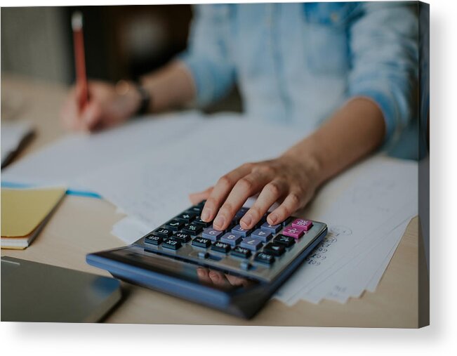 Telephone Acrylic Print featuring the photograph Student uses calculator to help with math homework by Eclipse_images