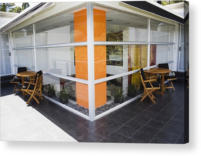 Built Structure Acrylic Print featuring the photograph Tables and chairs outside a house by Glowimages