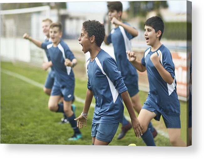 Soccer Uniform Acrylic Print featuring the photograph Team of Confident Young Male Footballers Running Onto Field by Xavierarnau