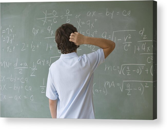Problems Acrylic Print featuring the photograph Teenaged boy looking at math equations on blackboard by Tetra Images