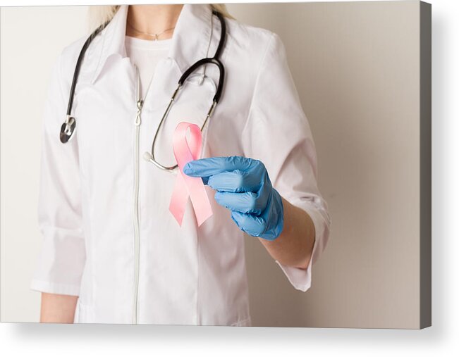 People Acrylic Print featuring the photograph Woman doctor holding a pink ribbon in her hands by Unomat