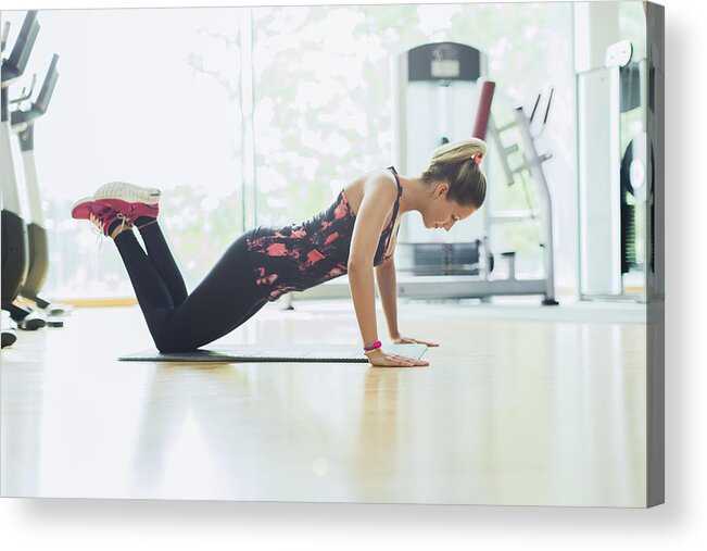 People Acrylic Print featuring the photograph Woman doing push-ups on knees at gym by Caia Image