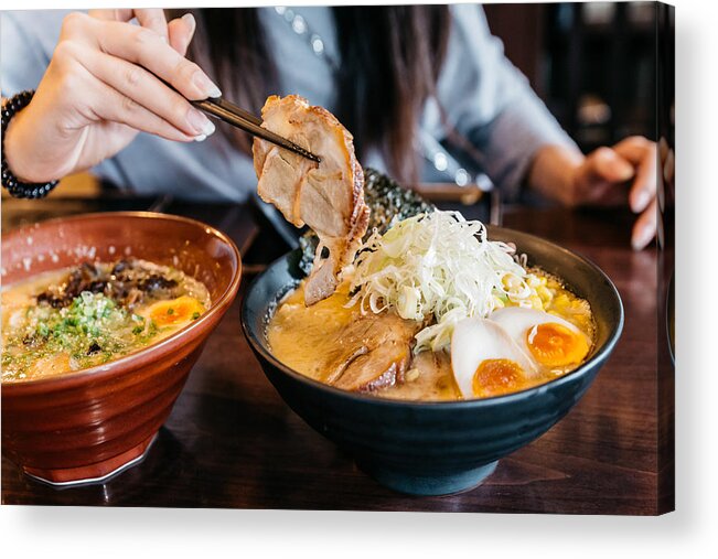 Cut Out Acrylic Print featuring the photograph Woman hand pinching noodle in Ramen Pork Bone Soup (Tonkotsu Ramen) with Chashu Pork, Scallion, Sprout, Corn, Dried Seaweed and boiled egg served in black bowl. by Artit_Wongpradu