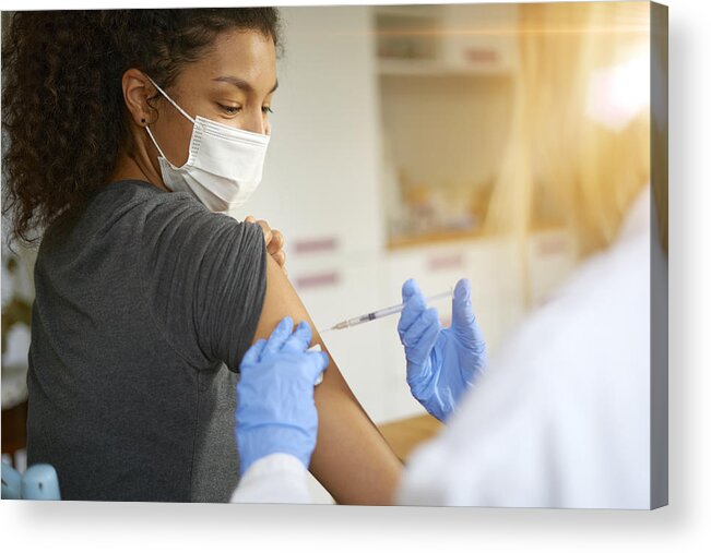 Expertise Acrylic Print featuring the photograph Young woman getting vaccinated by Andriy Onufriyenko
