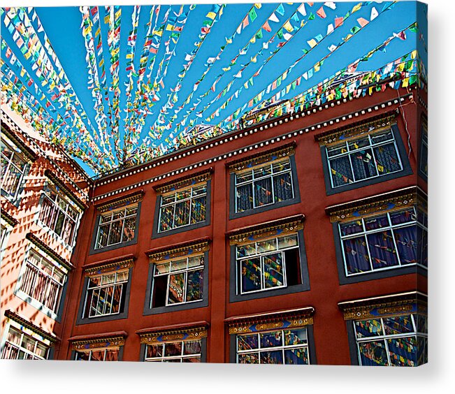 Prayer Flag Reflections Acrylic Print featuring the photograph Prayer Flag Reflections in Windows of Thangka Hotel in Lhasa-Tibet  by Ruth Hager