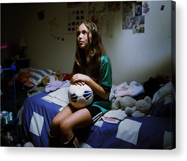 Soccer Uniform Acrylic Print featuring the photograph Teenage girl (12-14) sitting on bed with soccer ball by David Waldorf