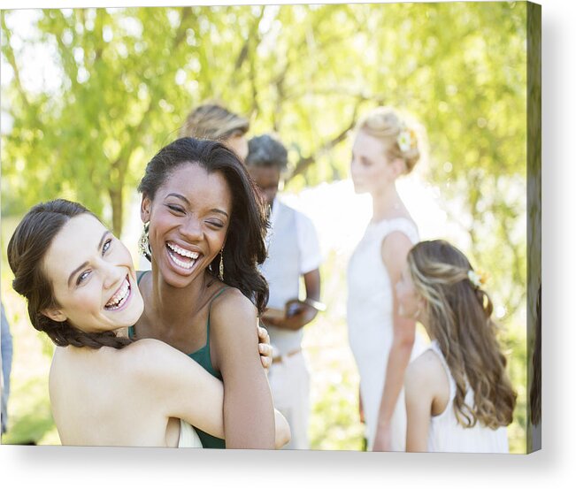 Young Men Acrylic Print featuring the photograph Bridesmaid and friend dancing during wedding reception in domestic garden by Caiaimage/Tom Merton