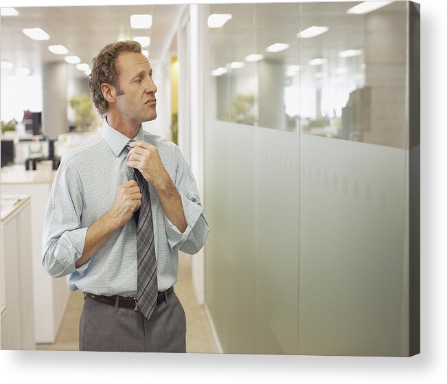 Corporate Business Acrylic Print featuring the photograph Businessman adjusting tie in office by Paul Bradbury